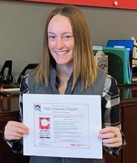 Cassie Chance, young woman with straight blond hair holding an award certificate 
